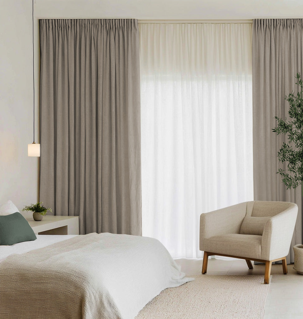 A pair of Carita Natural curtains with white sheer daytime curtains, linen elegance