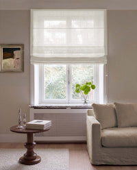 White linen Roman blind made of sheer linen. Living Room Window.