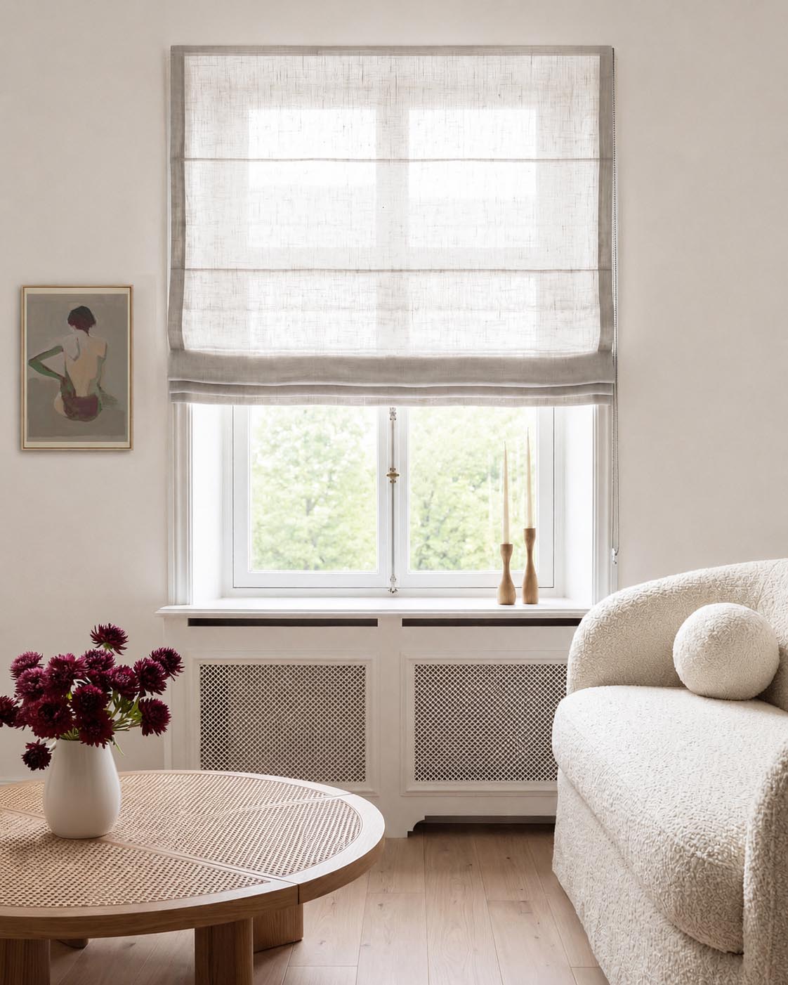 A light beige linen Roman blind with horizontal pleats, shown installed on a window.