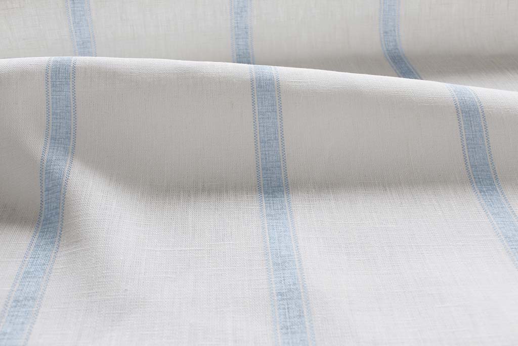 Rune Shadow Blue - vertical blue tone striped fabric.